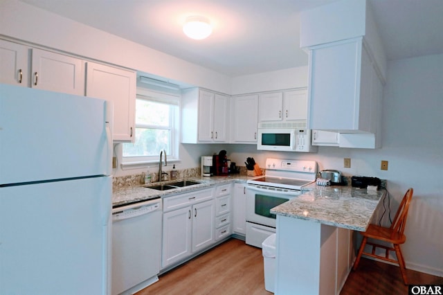 1006 Swordfish Way Unit 1006, Kitty Hawk, NC 27949 - kitchen with white appliances, a sink, a peninsula, and white cabinets