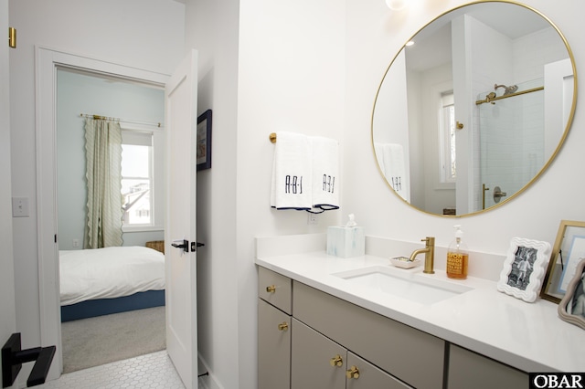 ensuite bathroom featuring walk in shower, connected bathroom, and vanity