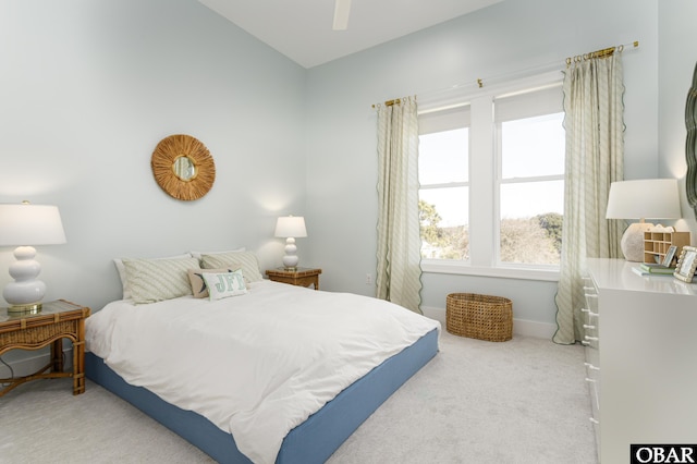 bedroom featuring baseboards, a ceiling fan, and light colored carpet