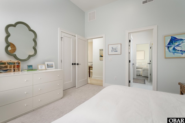 bedroom with light carpet and visible vents