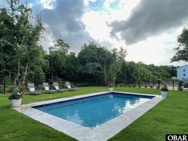 view of pool featuring a fenced in pool, fence, and a lawn