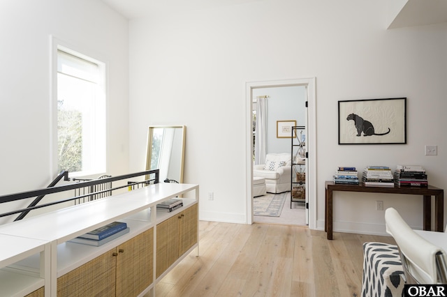 office area featuring light wood-type flooring and baseboards