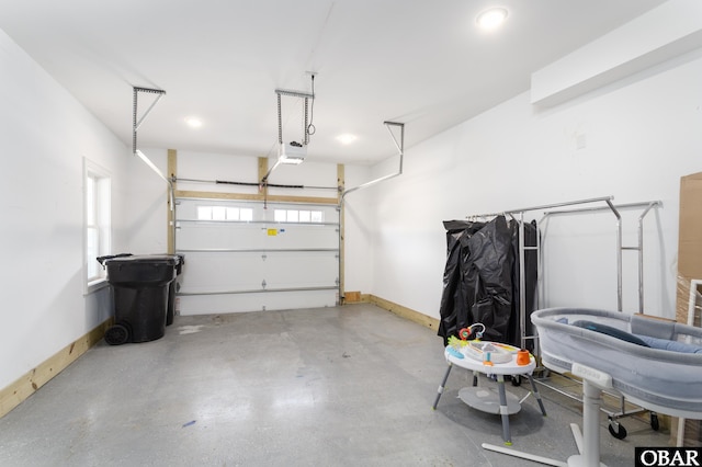 garage with a garage door opener and baseboards