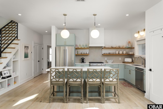 kitchen featuring appliances with stainless steel finishes, light countertops, and open shelves