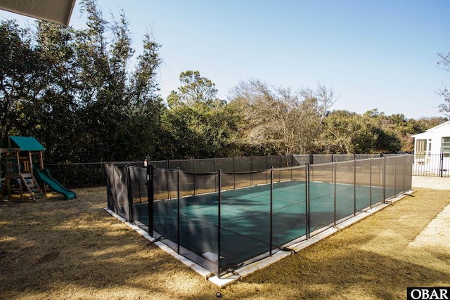 view of pool with a fenced in pool, a playground, and fence