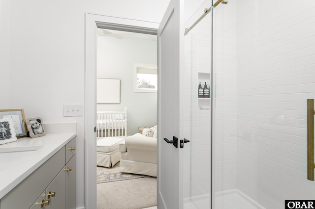 ensuite bathroom featuring a stall shower, vanity, and ensuite bath