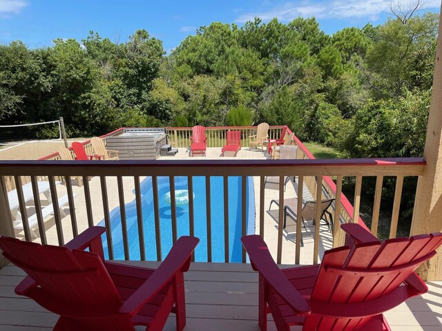 wooden deck featuring a hot tub and an outdoor pool