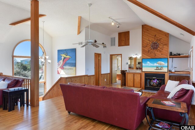 dining space featuring wood walls, wainscoting, and light wood-style floors