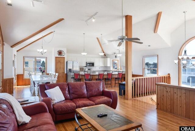 kitchen with hanging light fixtures, light wood-style flooring, white cabinetry, and stainless steel appliances