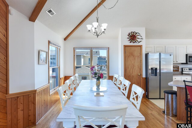 kitchen featuring lofted ceiling, pendant lighting, light countertops, and open floor plan