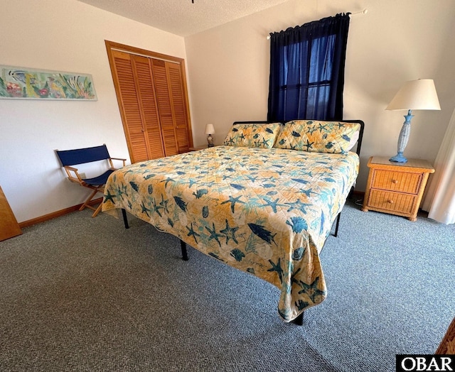 carpeted bedroom featuring a closet, a textured ceiling, and baseboards