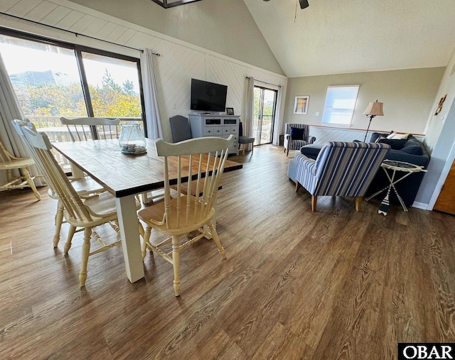 dining space featuring high vaulted ceiling, ceiling fan, and wood finished floors