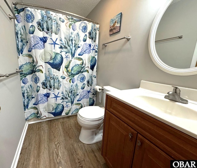 full bath featuring toilet, curtained shower, vanity, wood finished floors, and a textured ceiling
