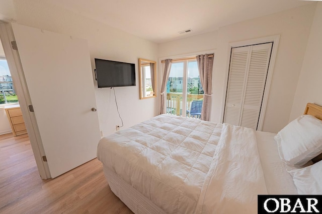 804 S Memorial Blvd Unit 3-D, Kill Devil Hills, NC 27948 - bedroom with light wood-style flooring, access to exterior, multiple windows, and a closet