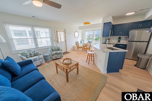 804 S Memorial Blvd Unit 3-D, Kill Devil Hills, NC 27948 - living room with light wood-style floors and a ceiling fan