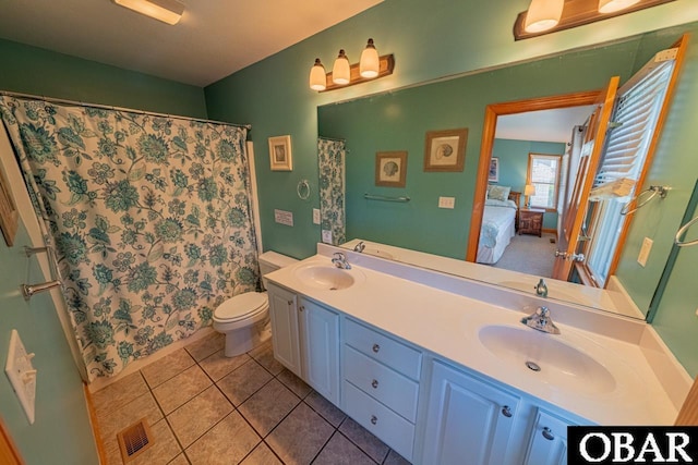 ensuite bathroom with double vanity, toilet, visible vents, and a sink