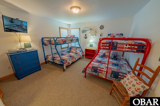 bedroom with baseboards and carpet