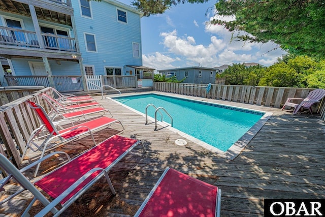 view of swimming pool with a fenced in pool and fence