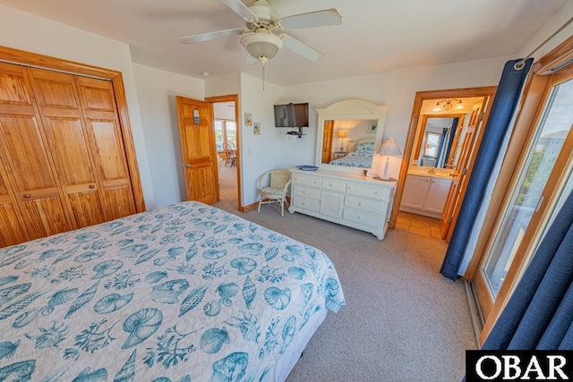 bedroom with a closet, multiple windows, a ceiling fan, and carpet floors