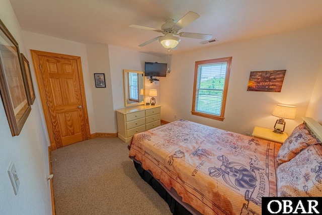 bedroom with visible vents, light carpet, baseboards, and ceiling fan