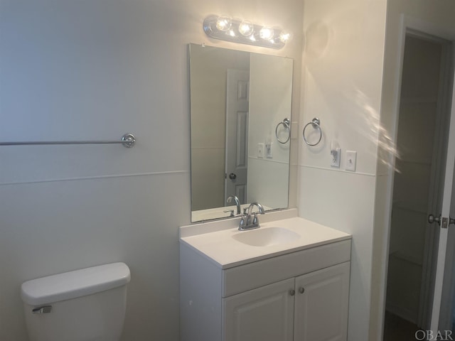 bathroom with toilet and vanity