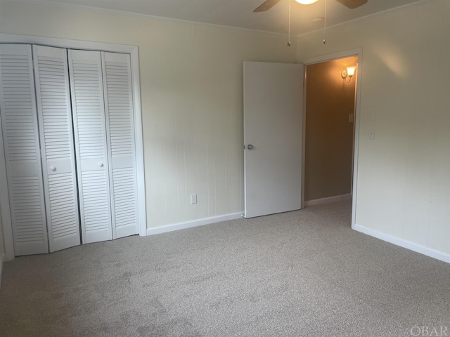 unfurnished bedroom with a ceiling fan, carpet, a closet, and baseboards