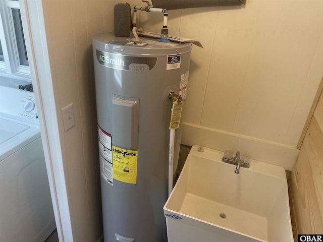 utilities with water heater, washer / clothes dryer, and a sink