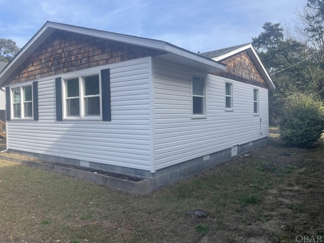 view of property exterior with crawl space and a lawn