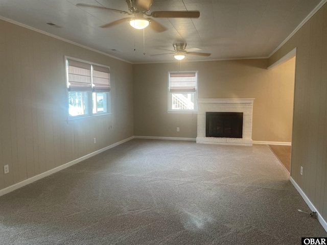 unfurnished living room with ornamental molding, carpet, a brick fireplace, and a healthy amount of sunlight