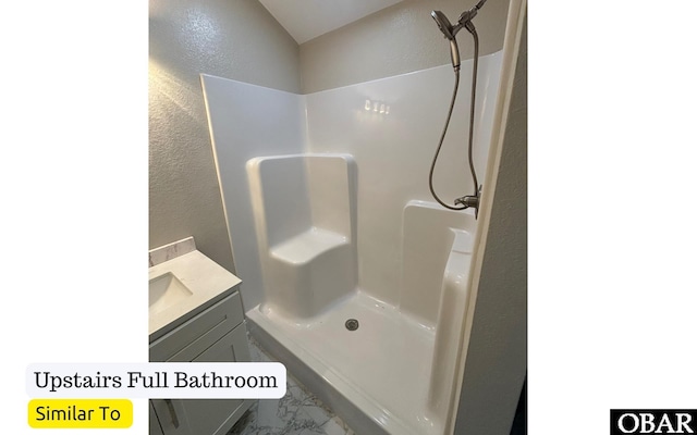 172 Charleston Dr Lot 163, Grandy, NC 27939 - full bath featuring a textured wall, vanity, marble look tiles, and a shower