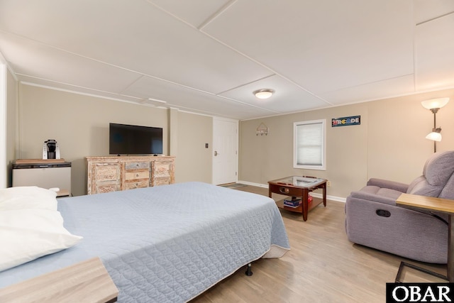 bedroom featuring light wood-style floors and baseboards