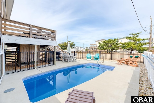 view of pool featuring a fenced in pool, stairs, outdoor dining area, a fenced backyard, and a patio