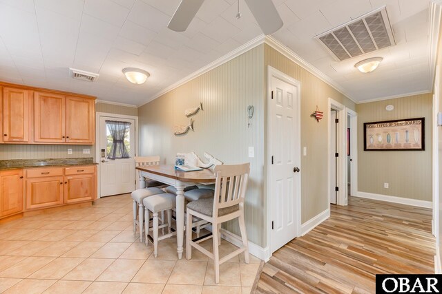 dining area featuring visible vents, baseboards, light tile patterned flooring, and crown molding