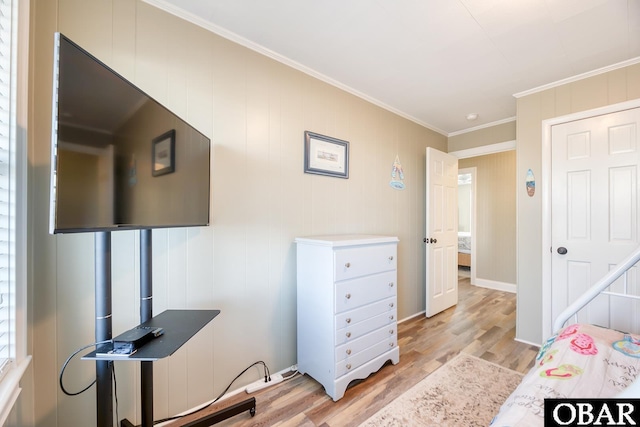 bedroom with crown molding and light wood-style flooring