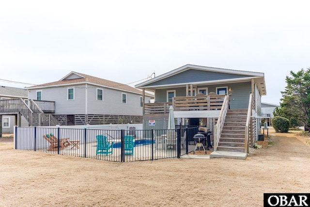 view of front of house featuring a patio area, stairway, and fence