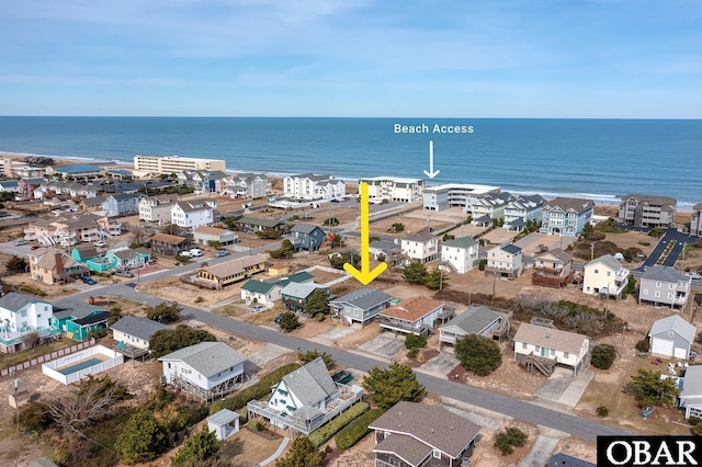 birds eye view of property with a water view and a residential view