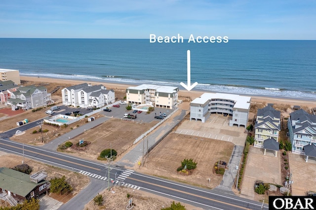 drone / aerial view featuring a view of the beach and a water view