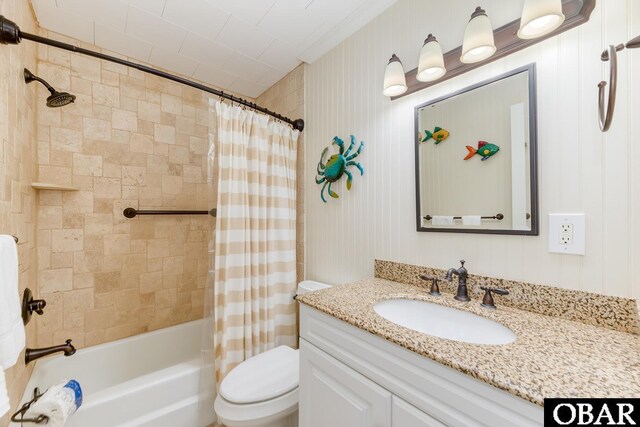 full bathroom featuring shower / bathtub combination with curtain, toilet, and vanity