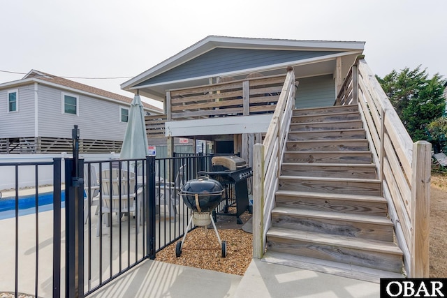 back of house featuring stairs and fence