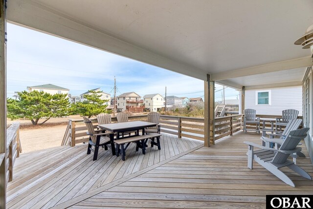 wooden terrace featuring outdoor dining area