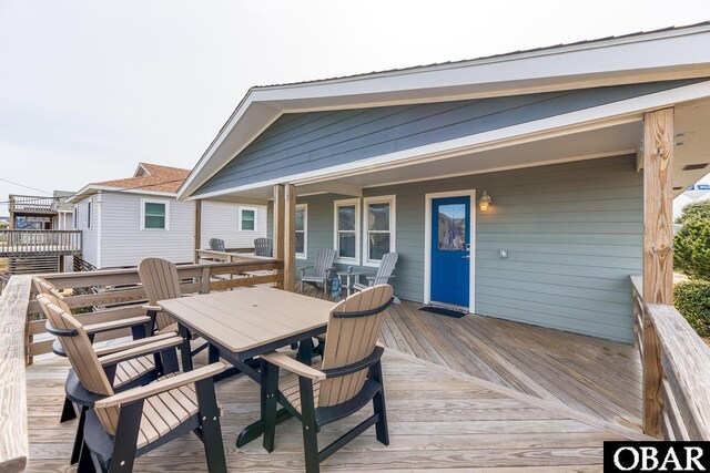 wooden deck featuring outdoor dining space