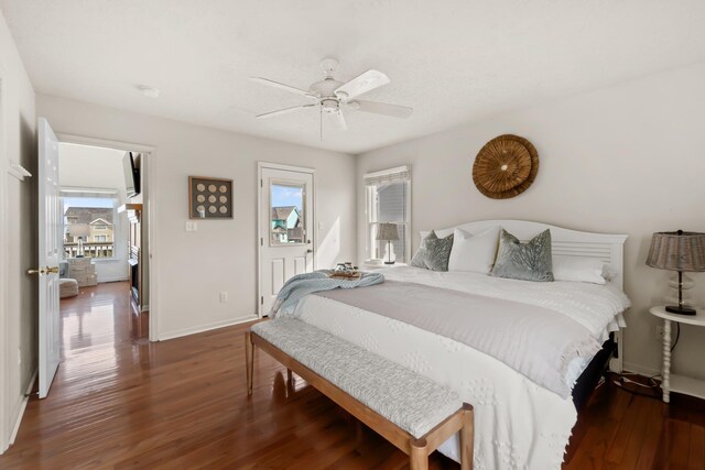 bedroom featuring baseboards, dark wood finished floors, and a ceiling fan