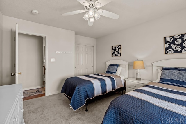 bedroom featuring light carpet, baseboards, a ceiling fan, and a closet