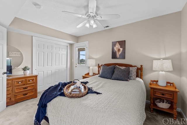 bedroom featuring light carpet, ceiling fan, a closet, and visible vents