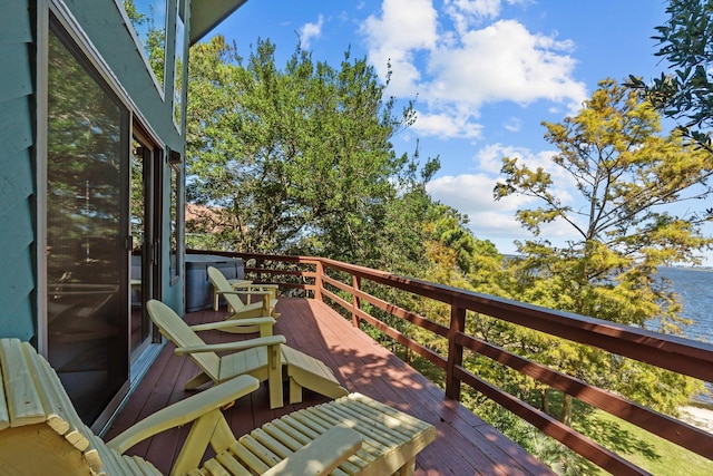 wooden terrace featuring a water view