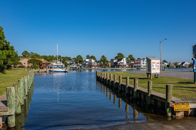 dock area with a residential view and a water view