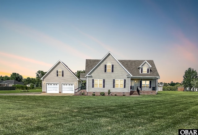 view of front facade featuring a porch, a lawn, a garage, crawl space, and driveway