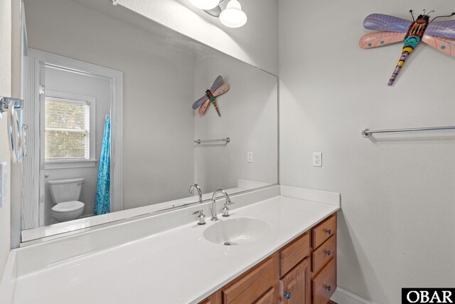 bathroom featuring toilet and vanity