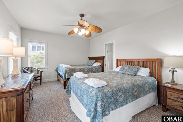 carpeted bedroom featuring baseboards and ceiling fan