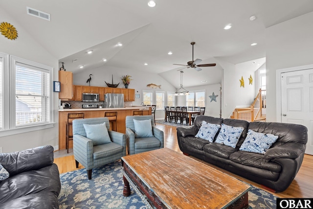 living area with ceiling fan, visible vents, recessed lighting, stairs, and light wood-style flooring